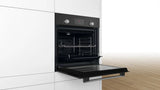 Bosch HHF113BA0B Built-in Single Oven with fitted 13Amp Plug in Black from HomeWise Appliances stock photo showing oven in a kitchen cabinet with the door open.